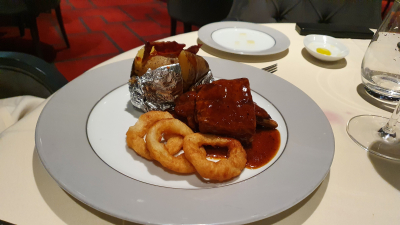 BBQ and vanilla glazed Baby Pork Ribs with oven-roasted potatoes and onion rings